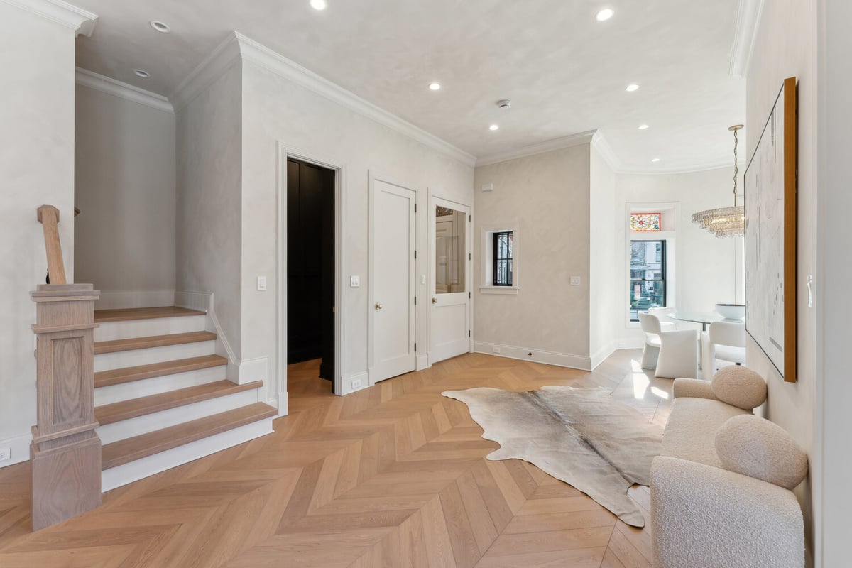 Bright hallway and staircase with access to dining space in a custom DesignLab home in Rhode Island