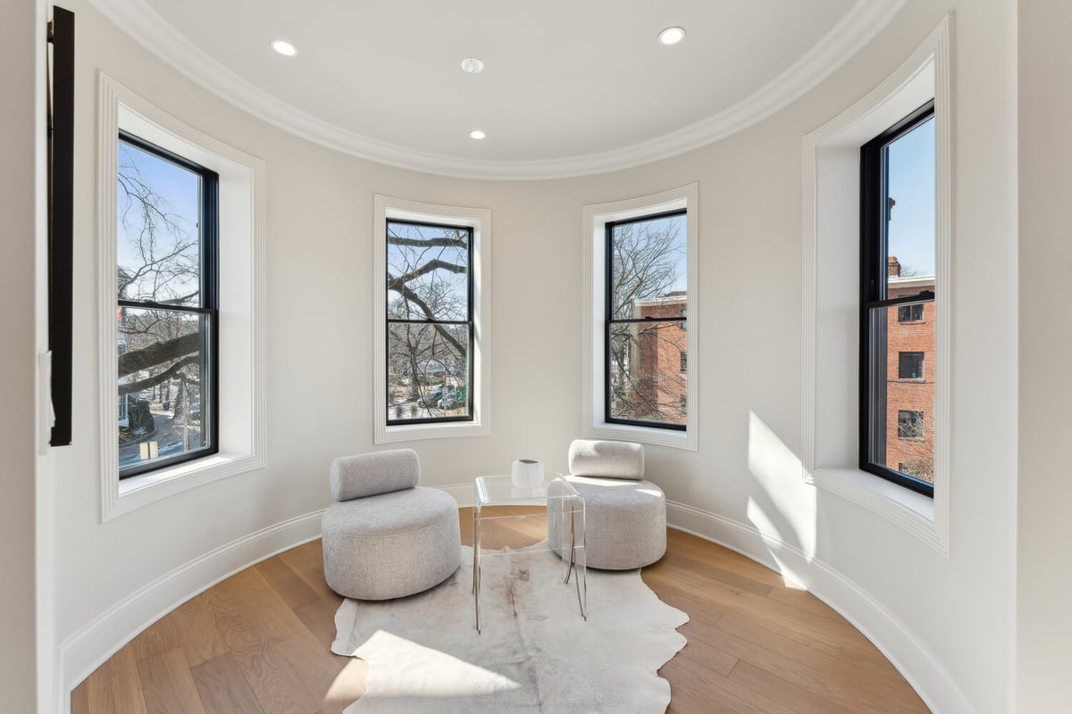 Bright sitting nook with three tall windows in a custom home by DesignLab in Rhode Island