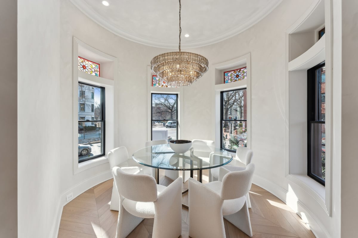 Circular dining area with modern chandelier in a Rhode Island custom home by DesignLab