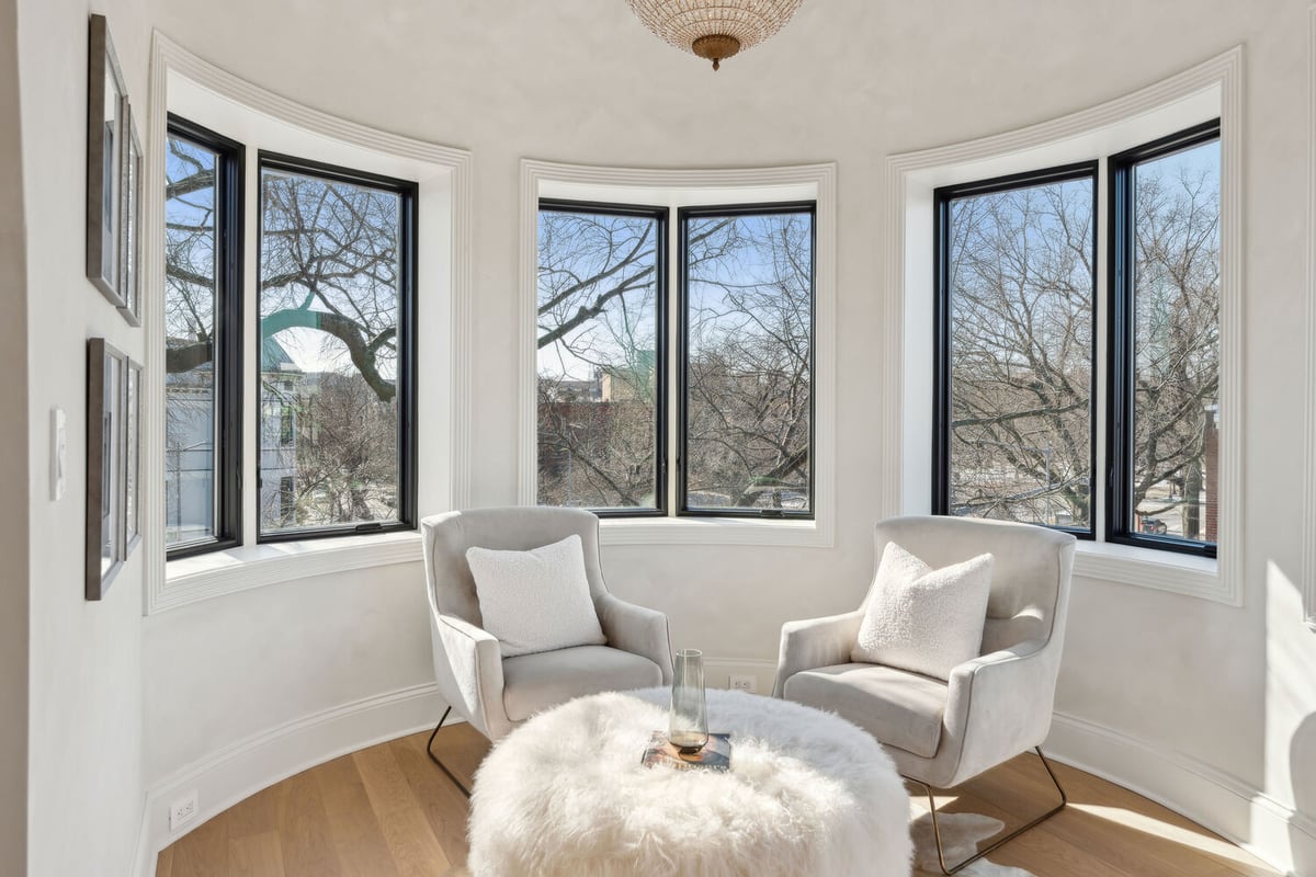 Cozy bay window sitting area with accent chairs in a Rhode Island custom home by DesignLab
