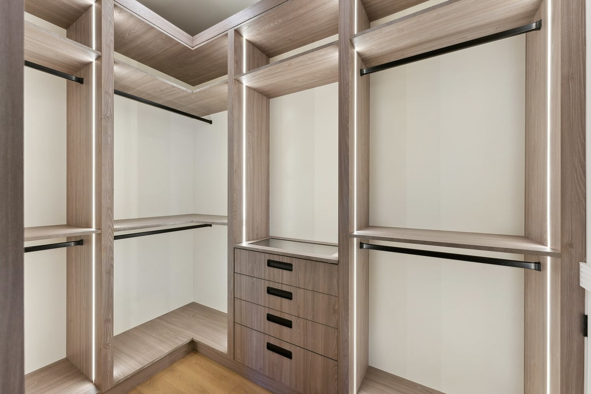 Custom walk-in closet with LED-lit wood shelving by DesignLab in McLean, VA