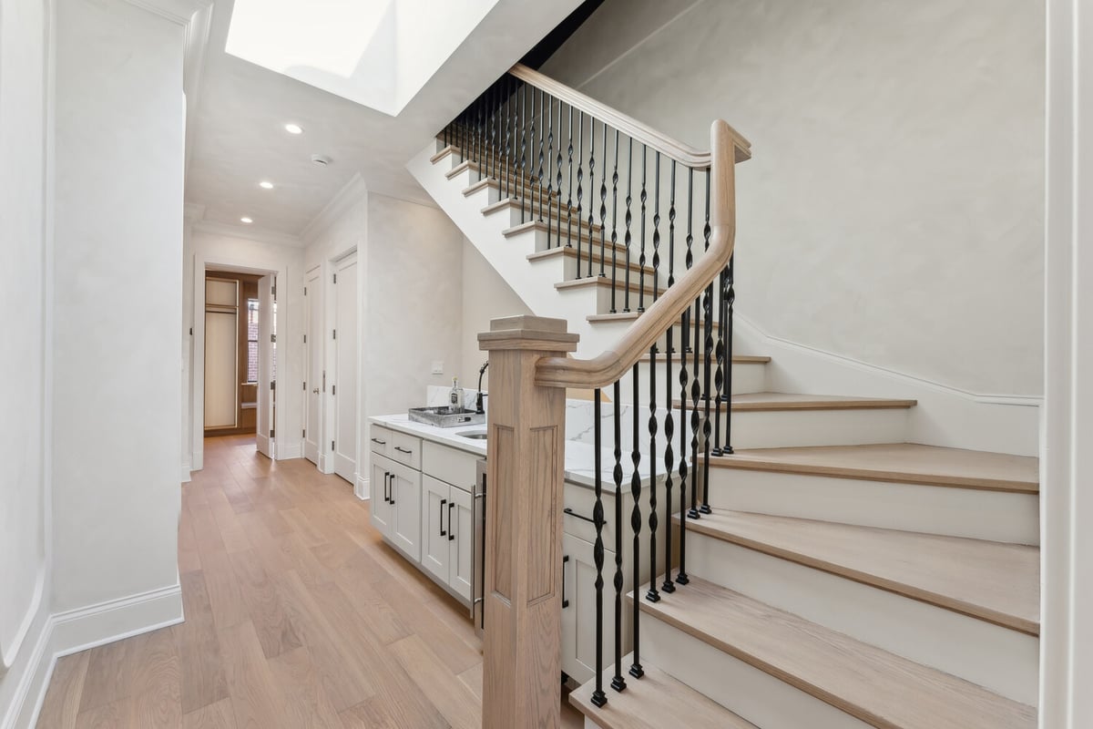 Elegant stairway with iron balusters in a DesignLab custom home in Rhode Island