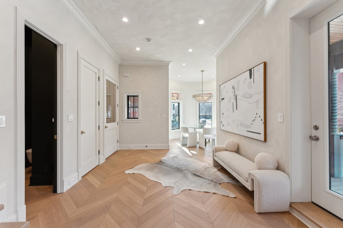 Entryway leading to dining area with modern art in a DesignLab custom home in Rhode Island