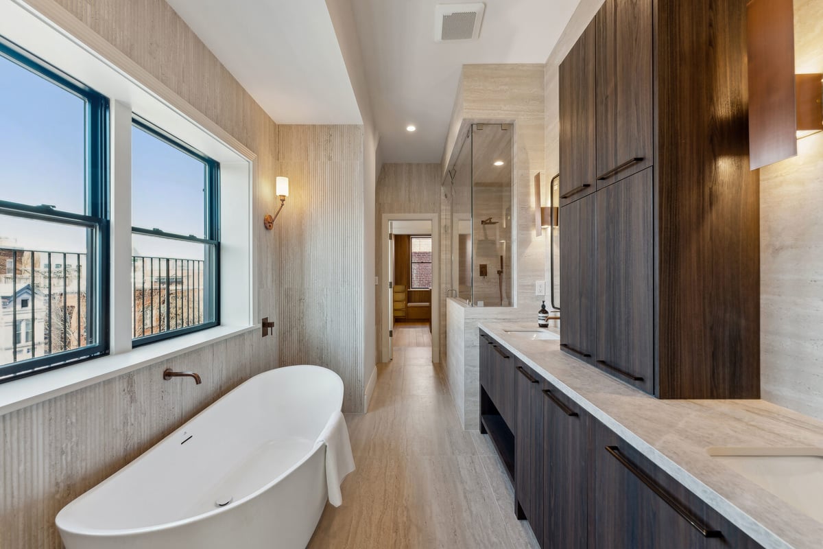 Luxury bathroom with freestanding tub and modern fixtures in a Rhode Island home by DesignLab