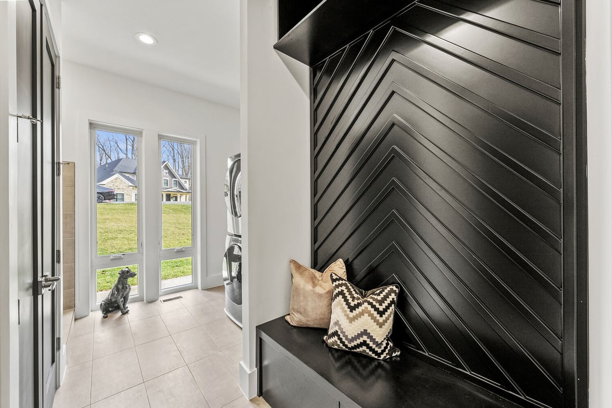 Custom entry and laundry combo featuring modern black built-ins by DesignLab in Kalorama, DC