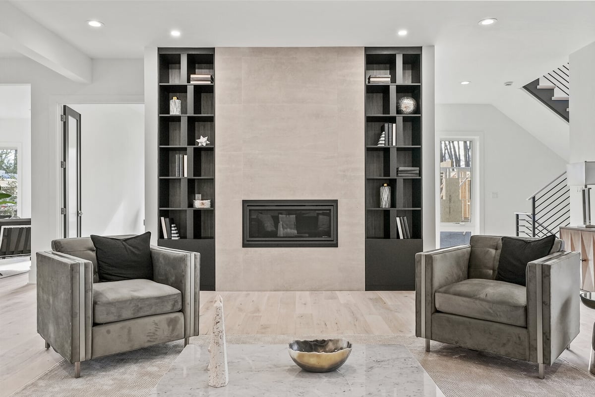 Living room with tile fireplace surround and black built-in bookshelves by DesignLab in Georgetown, DC