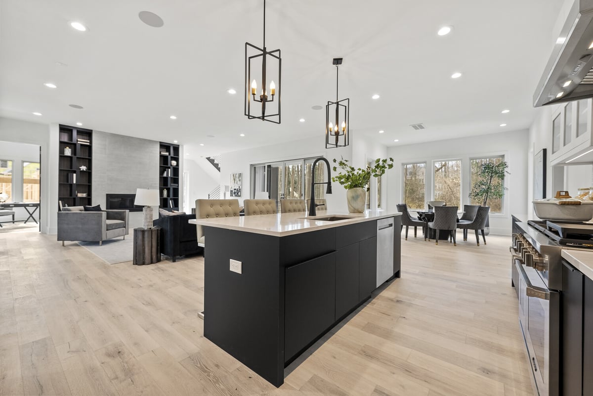 Open-concept kitchen, dining, and living area with natural light in River Oaks whole home by DesignLab