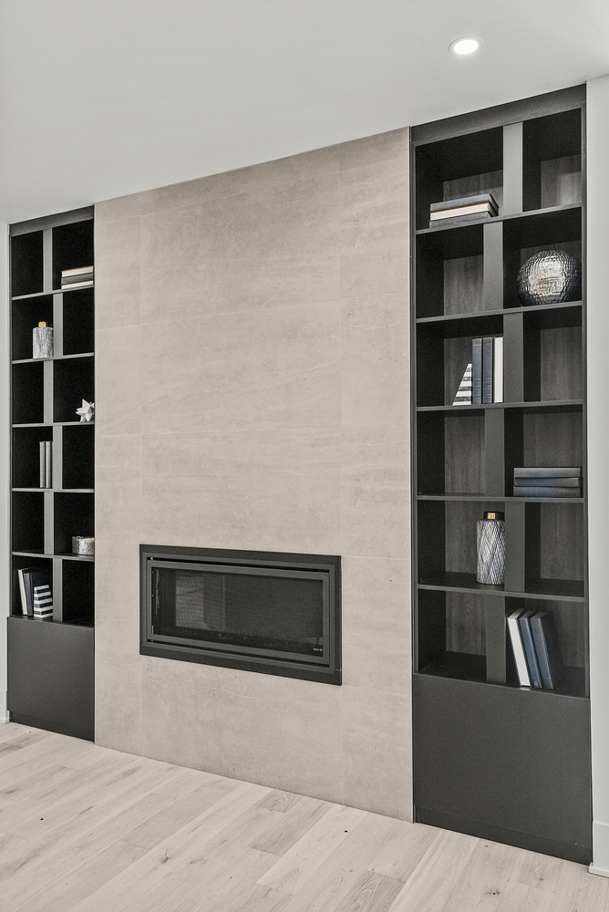 Sleek built-in fireplace with surrounding black shelving in a DesignLab custom home in Georgetown, DC