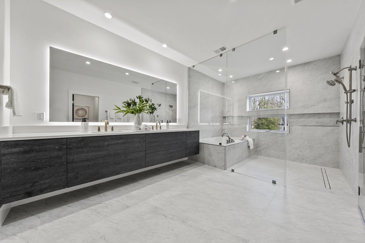 Spacious luxury bathroom in River Oaks home by DesignLab with large shower and soaking tub