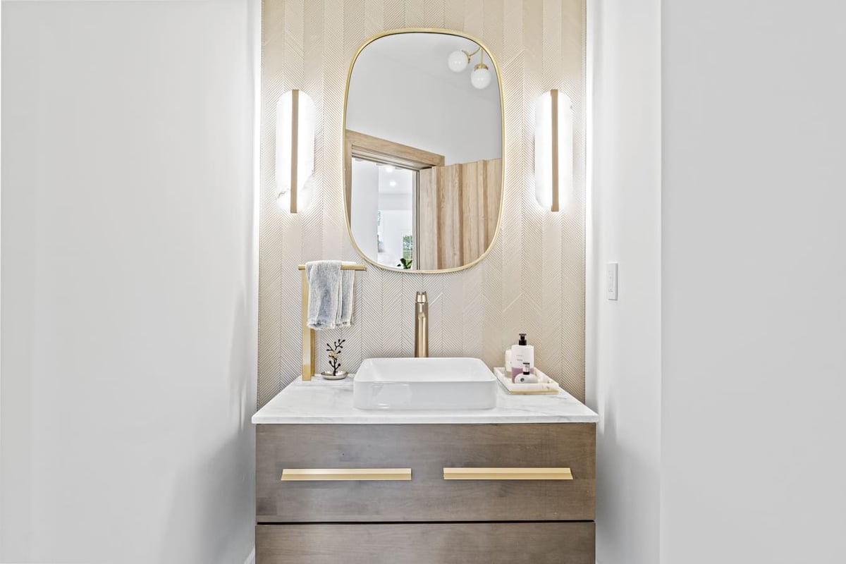 Compact bathroom makeover with vessel sink and gold mirror frame by DesignLab in Washington DC Metro